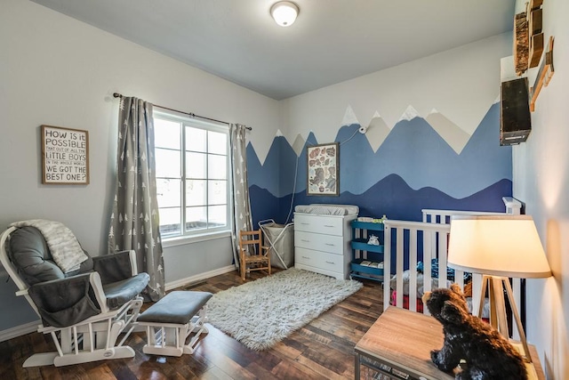 bedroom with baseboards and wood finished floors