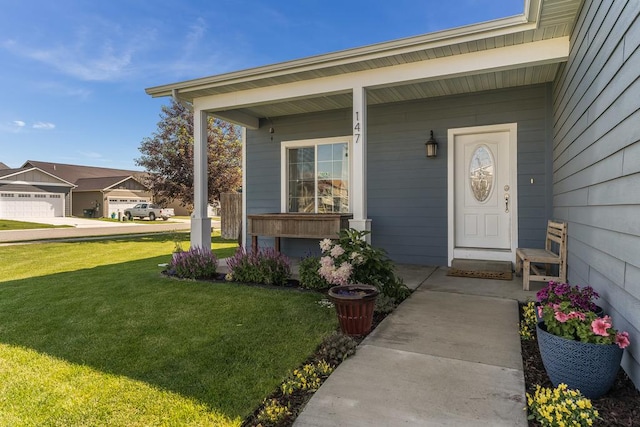 property entrance with covered porch and a yard