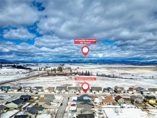 snowy aerial view with a residential view