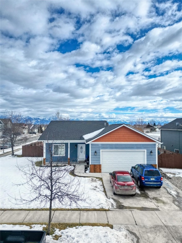 single story home with driveway, a garage, and fence