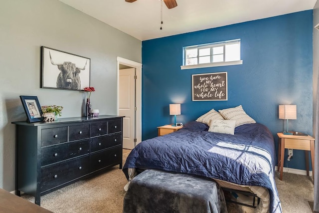 carpeted bedroom featuring ceiling fan and baseboards