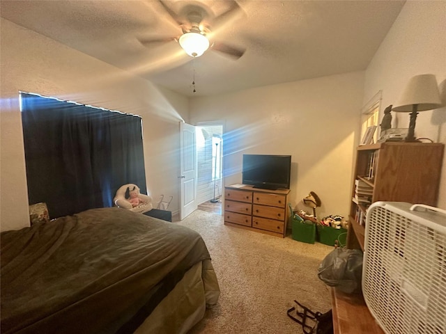 bedroom with a ceiling fan and carpet flooring