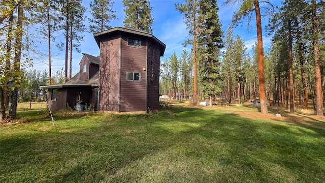 exterior space featuring a yard and a barn