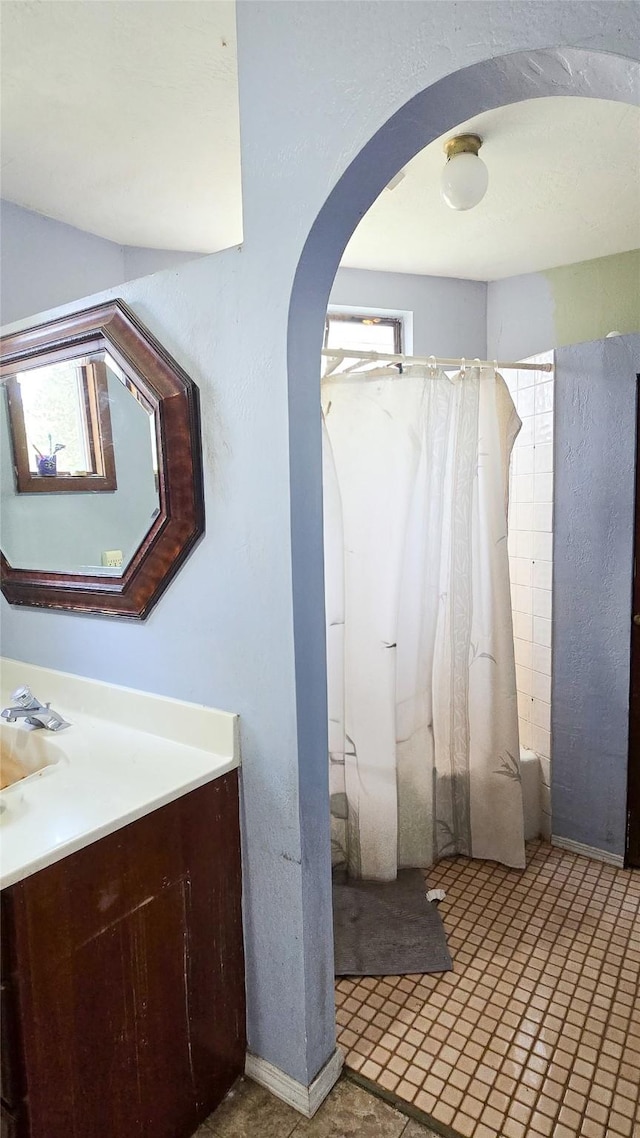 bathroom featuring shower / bathtub combination with curtain and vanity