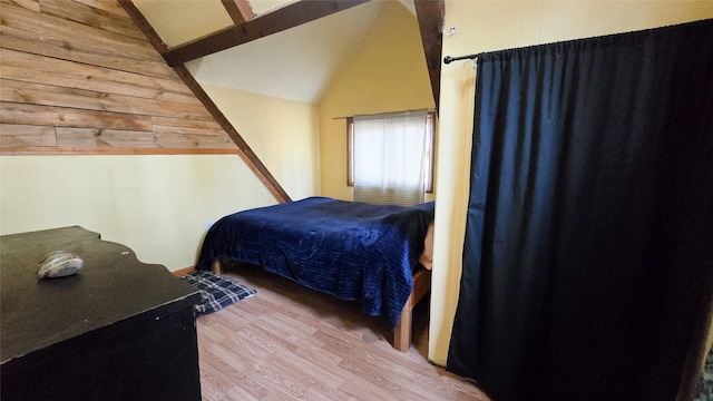 bedroom featuring lofted ceiling and light wood finished floors