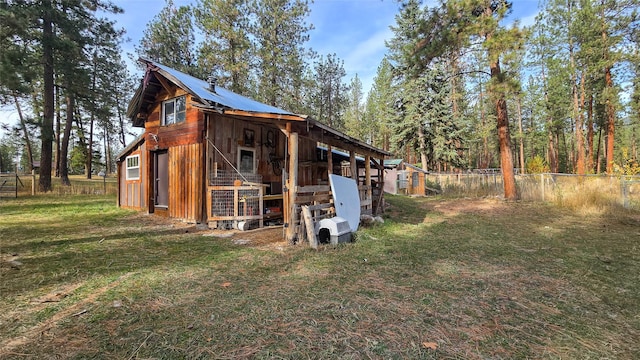 exterior space with an outbuilding and fence