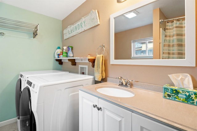 bathroom with independent washer and dryer and vanity