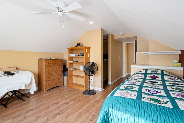 bedroom with ceiling fan, baseboards, vaulted ceiling, and wood finished floors