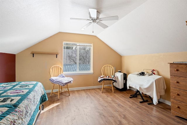 bedroom featuring vaulted ceiling, baseboards, and wood finished floors