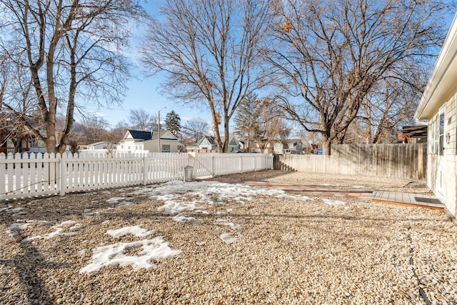 view of yard featuring a fenced backyard and a residential view