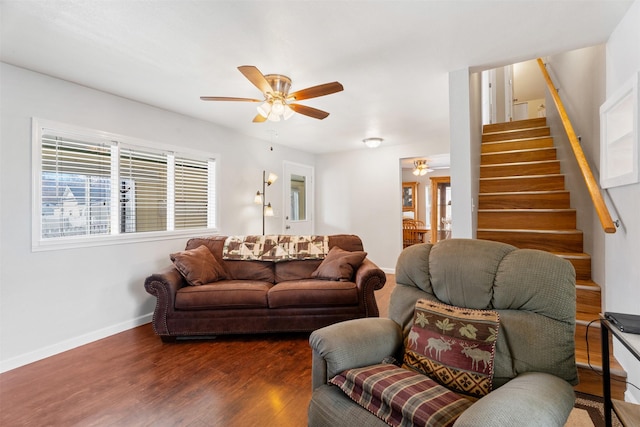 living room with dark wood-style floors, ceiling fan, stairs, and baseboards