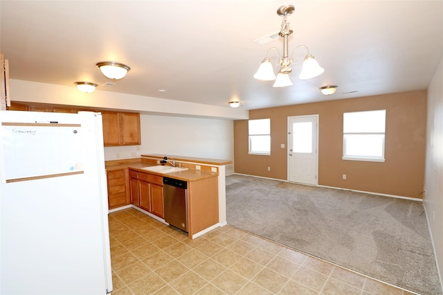 kitchen with light colored carpet, freestanding refrigerator, a peninsula, stainless steel dishwasher, and a sink