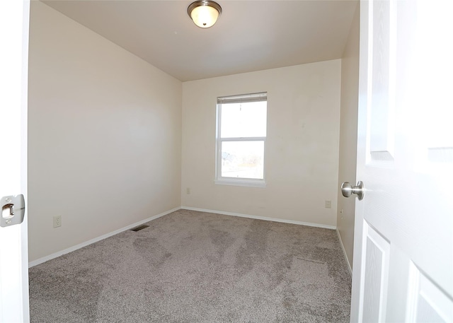 carpeted empty room with visible vents and baseboards