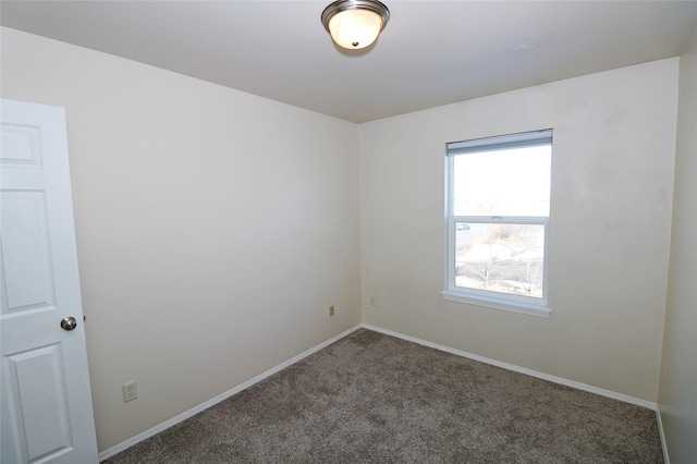 carpeted empty room with baseboards