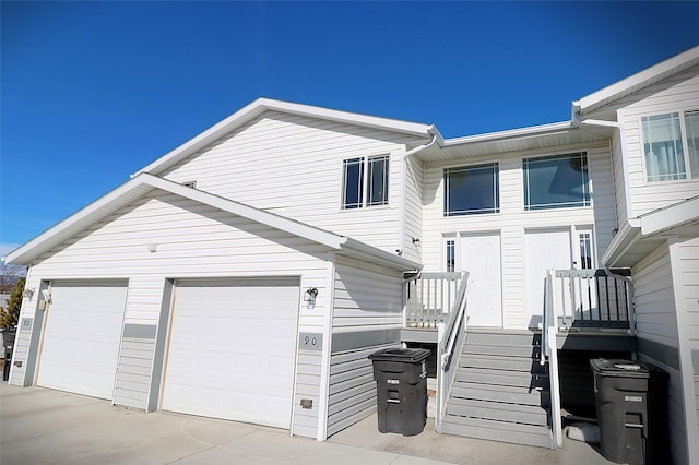 view of front of home with concrete driveway and an attached garage