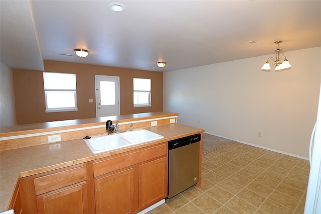 kitchen featuring decorative light fixtures, light countertops, stainless steel dishwasher, an inviting chandelier, and a sink