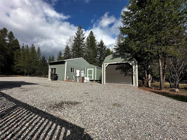 22 Pinewoods Dr, Trout Creek, MT 59874 - view of front of property with an outbuilding, a detached garage, and gravel driveway