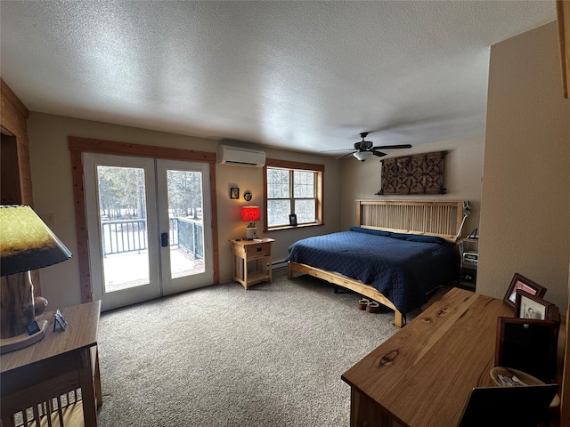 bedroom with a textured ceiling, a wall mounted air conditioner, access to outside, french doors, and carpet