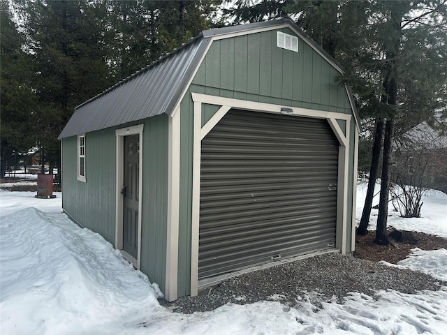 snow covered structure featuring an outdoor structure