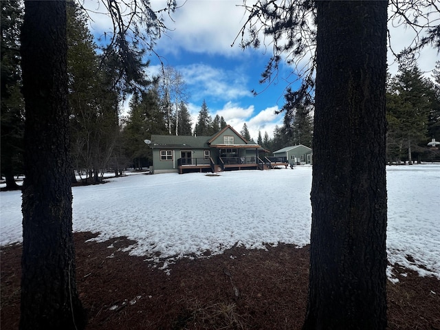 yard covered in snow with a wooden deck