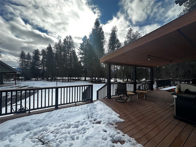 snow covered deck featuring area for grilling