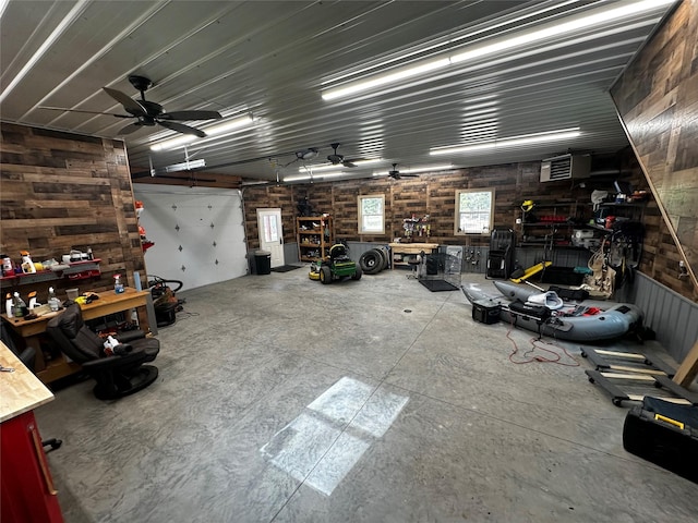 22 Pinewoods Dr, Trout Creek, MT 59874 - garage featuring a workshop area, wooden walls, and a ceiling fan