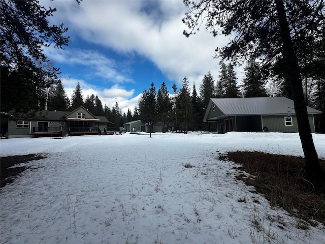 snowy yard featuring a garage