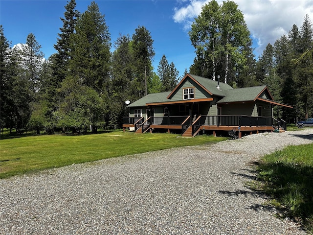 22 Pinewoods Dr, Trout Creek, MT 59874 - view of front of house with a front yard and view of wooded area