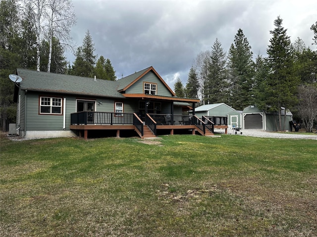 22 Pinewoods Dr, Trout Creek, MT 59874 - view of front of property featuring an outbuilding, a front lawn, a detached garage, and a wooden deck