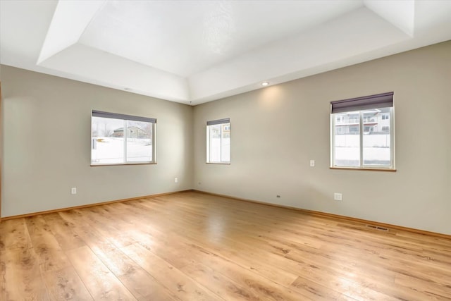 6864 Joy Dr, Missoula, MT 59803 - empty room featuring a raised ceiling, light wood-style floors, and baseboards