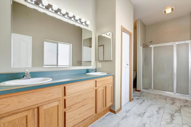 6864 Joy Dr, Missoula, MT 59803 - full bath with marble look tiles, a stall shower, double vanity, and toilet