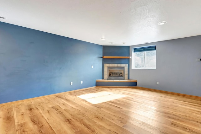 6864 Joy Dr, Missoula, MT 59803 - unfurnished living room with a fireplace, wood finished floors, baseboards, and recessed lighting