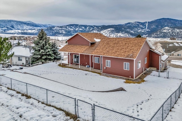 6864 Joy Dr, Missoula, MT 59803 - view of front of home with fence and a mountain view