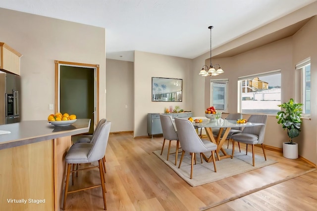 6864 Joy Dr, Missoula, MT 59803 - dining area with light wood finished floors, a chandelier, and baseboards