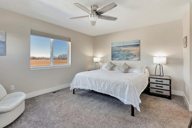 carpeted bedroom featuring ceiling fan, visible vents, and baseboards