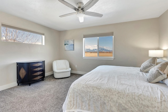 bedroom with ceiling fan, carpet flooring, and baseboards