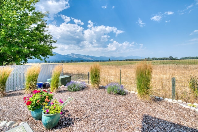 view of yard featuring a rural view and fence