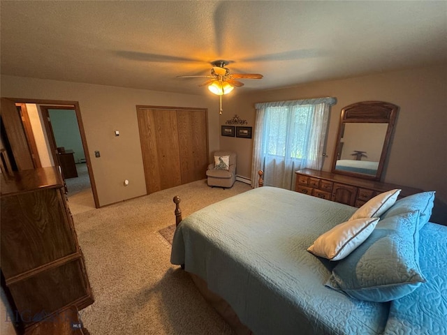 bedroom with light carpet, a closet, baseboard heating, and a ceiling fan