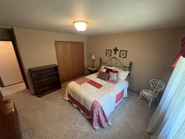 carpeted bedroom with a closet and a textured ceiling