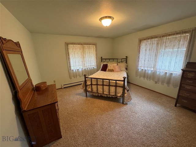 carpeted bedroom featuring baseboard heating