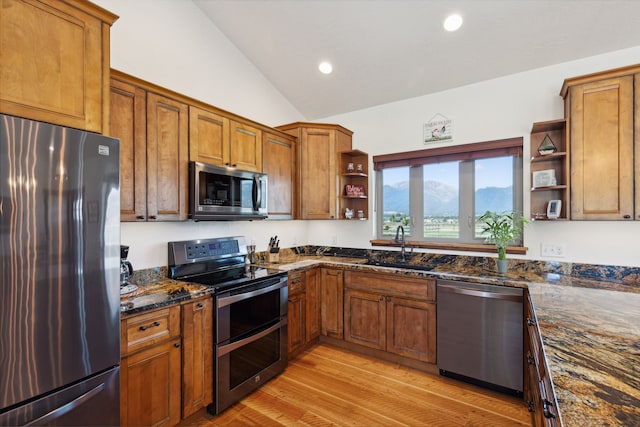 4416 Gem Ranch Rd, Stevensville, MT 59870 - kitchen featuring stainless steel appliances, open shelves, vaulted ceiling, brown cabinetry, and recessed lighting