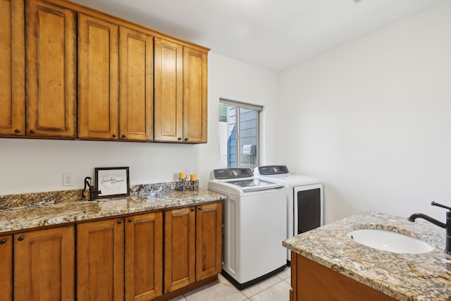 4416 Gem Ranch Rd, Stevensville, MT 59870 - washroom featuring washer and clothes dryer, light tile patterned floors, and cabinet space