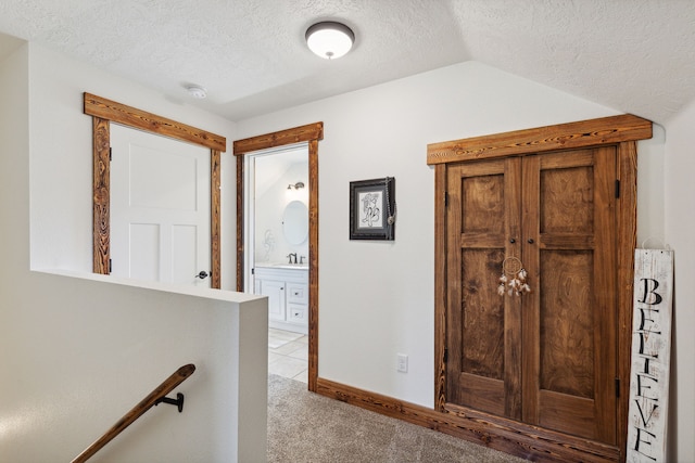 4416 Gem Ranch Rd, Stevensville, MT 59870 - hallway with a textured ceiling, light carpet, an upstairs landing, and lofted ceiling