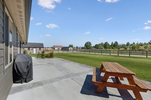 4416 Gem Ranch Rd, Stevensville, MT 59870 - view of patio / terrace with grilling area, a rural view, and an outbuilding