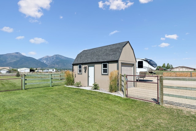 4416 Gem Ranch Rd, Stevensville, MT 59870 - view of outdoor structure with a fenced backyard, a mountain view, and a gate