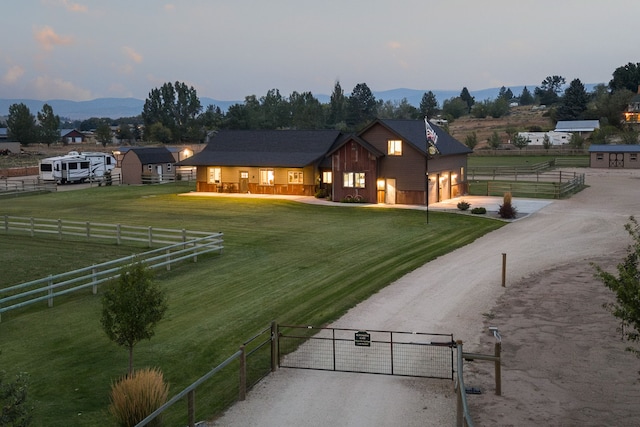 4416 Gem Ranch Rd, Stevensville, MT 59870 - view of front of house featuring dirt driveway, a garage, a gate, and a mountain view