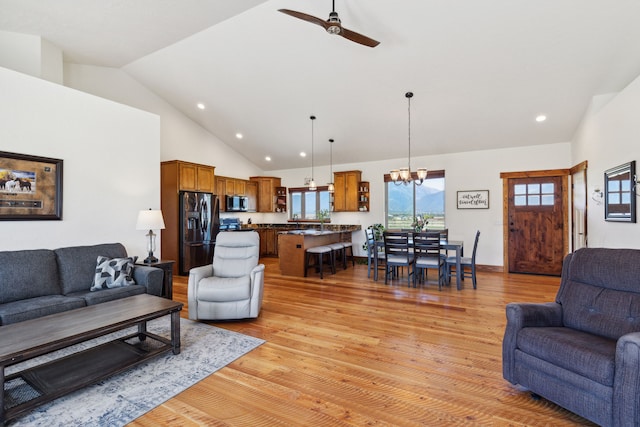 4416 Gem Ranch Rd, Stevensville, MT 59870 - living room with light wood-type flooring, ceiling fan, a chandelier, recessed lighting, and high vaulted ceiling