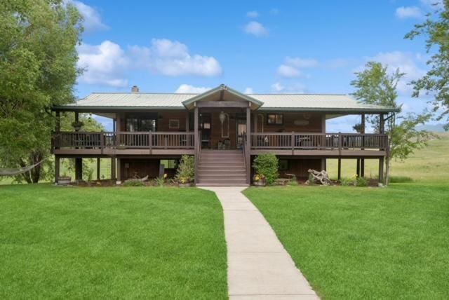 view of front of house featuring stairs, a front yard, and a wooden deck