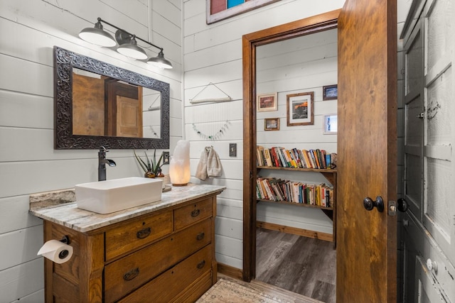 65637 Mt Highway 37, Eureka, MT 59917 - bathroom with wood finished floors, vanity, and wood walls