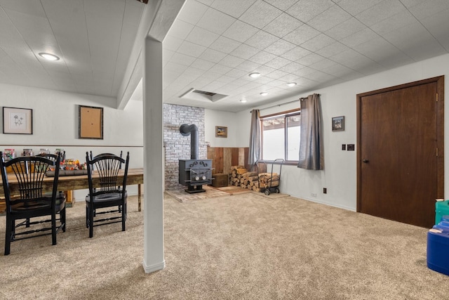 65637 Mt Highway 37, Eureka, MT 59917 - carpeted dining area with a wood stove, wainscoting, and wooden walls